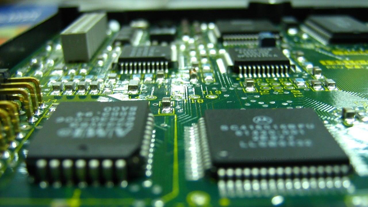 A green motherboard with large processor chips